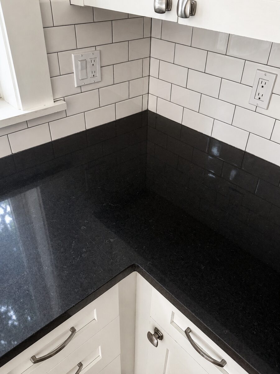 Clean kitchen counter and tile backsplash