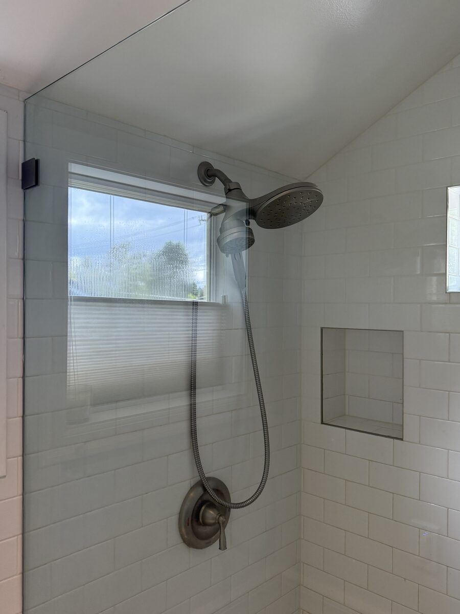 Restored glass shower door, hard water buildup removed